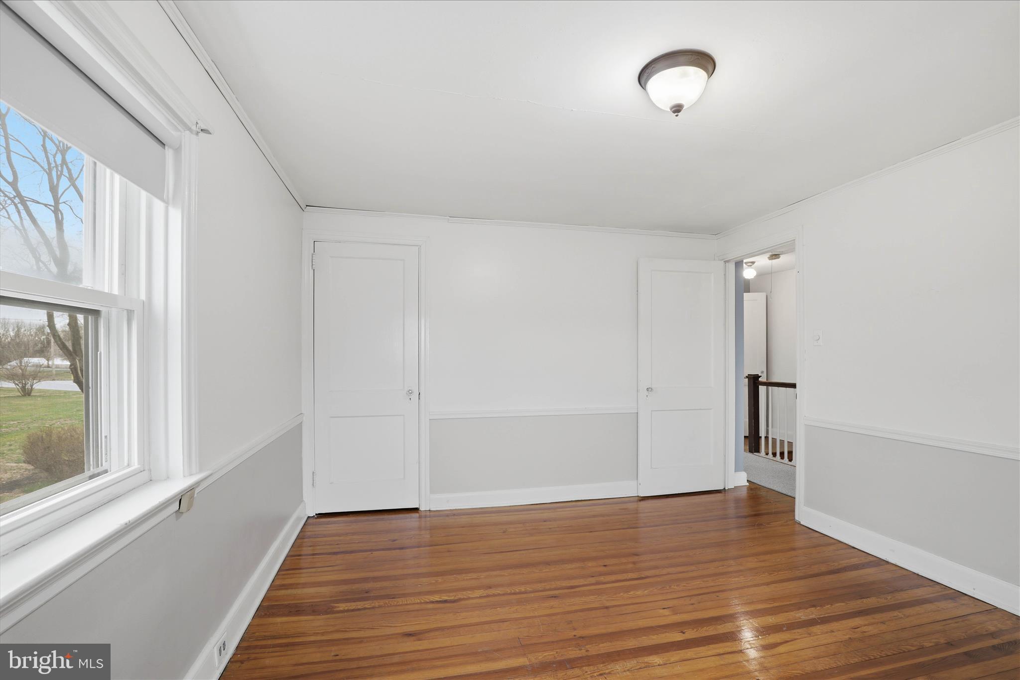 1632 Lampeter Road Lancaster, PA 17602 - Photo 29 of 46 a view of an empty room with wooden floor and a window