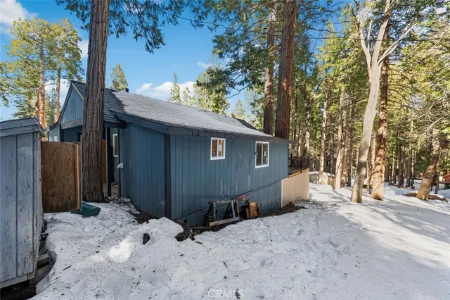 a view of a house with a snow in the yard