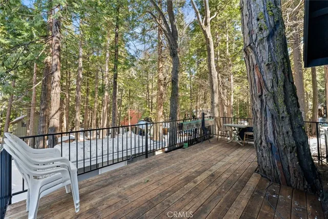 a view of a roof deck with wooden floor and fence