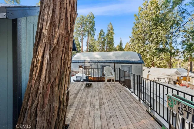 a view of a balcony with wooden floor and bench