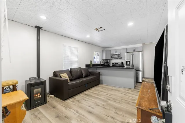 a living room with a couch and a kitchen view