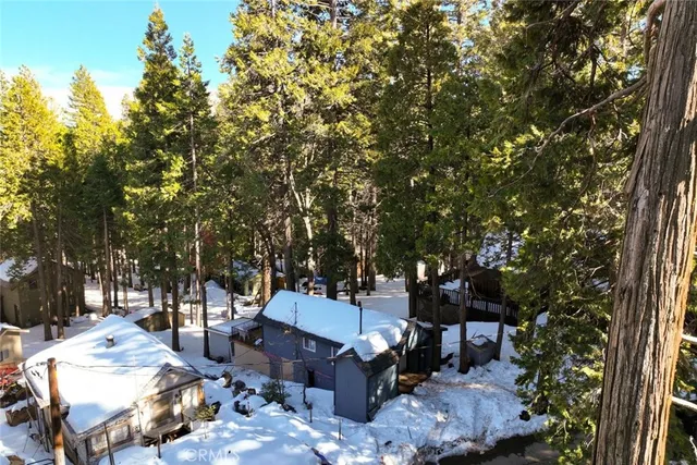 a view of a backyard with furniture and a tree
