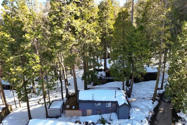 an aerial view of a house with a yard basket ball court and outdoor seating