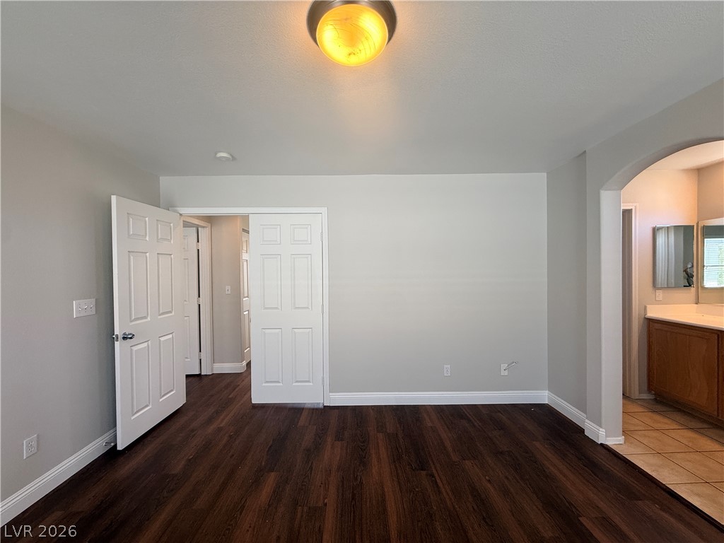 11953 Fairfax Ridge Street Las Vegas, NV 89183 - Photo 25 of 32 Rich hardwood-style flooring extends into this versatile room with convenient access to a well-appointed bathroom.