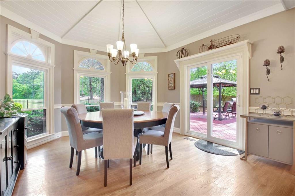110 Sandtrap Ridge Peachtree City, GA 30269 - Photo 21 of 85 a view of a dining room with furniture a chandelier and wooden floor