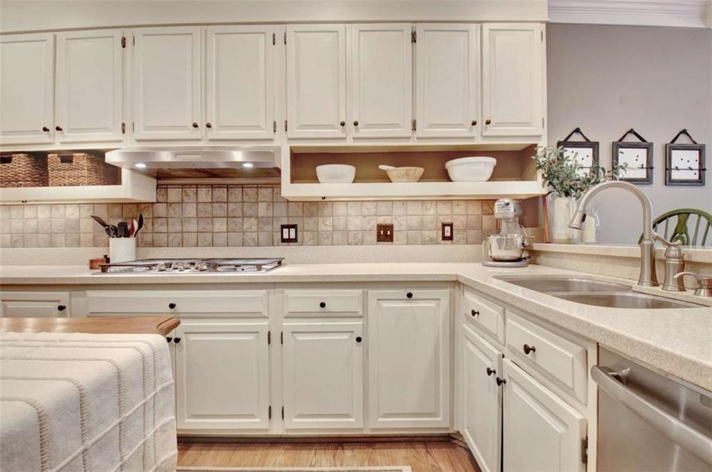 110 Sandtrap Ridge Peachtree City, GA 30269 - Photo 23 of 85 a kitchen with white cabinets and a sink