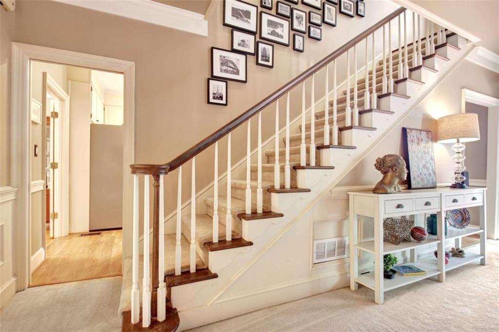 110 Sandtrap Ridge Peachtree City, GA 30269 - Photo 41 of 85 a view of staircase with lots of frames on wall and a large window