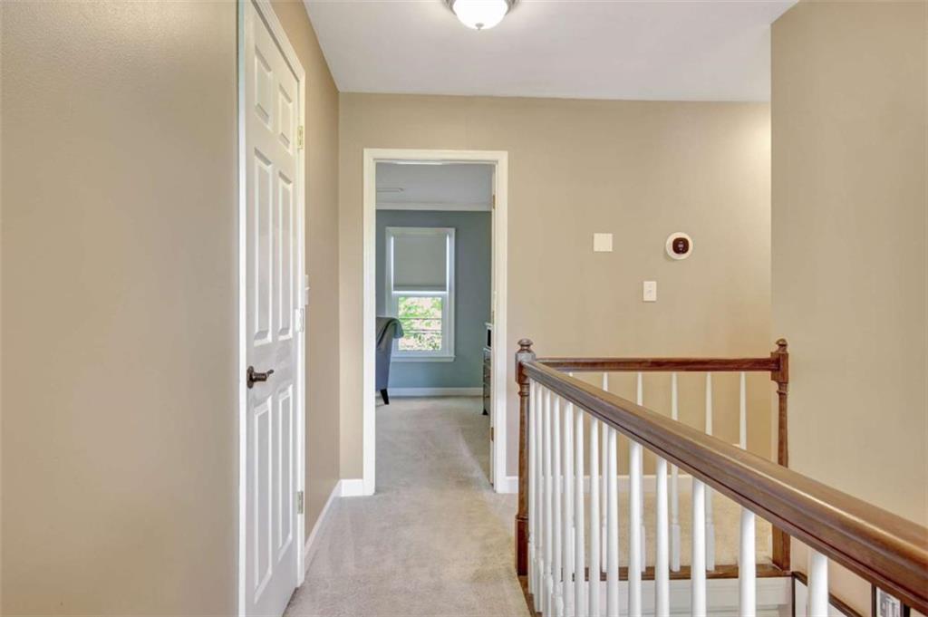 110 Sandtrap Ridge Peachtree City, GA 30269 - Photo 42 of 85 a view of a hallway with wooden floor and staircase