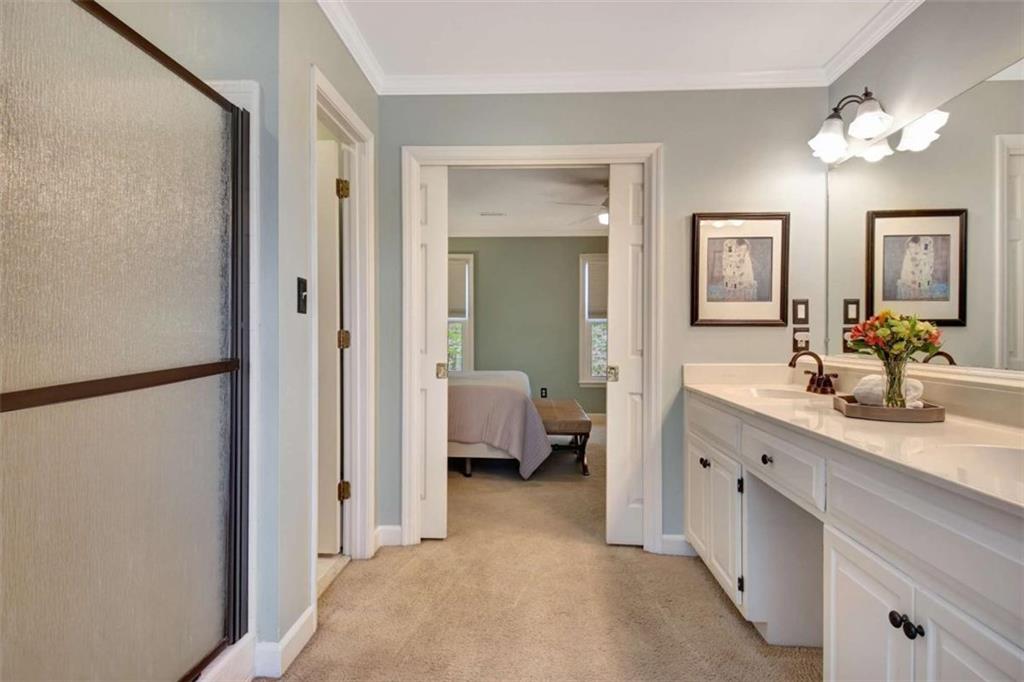 110 Sandtrap Ridge Peachtree City, GA 30269 - Photo 52 of 85 a en suite bathroom with a sink a mirror a lamp and window