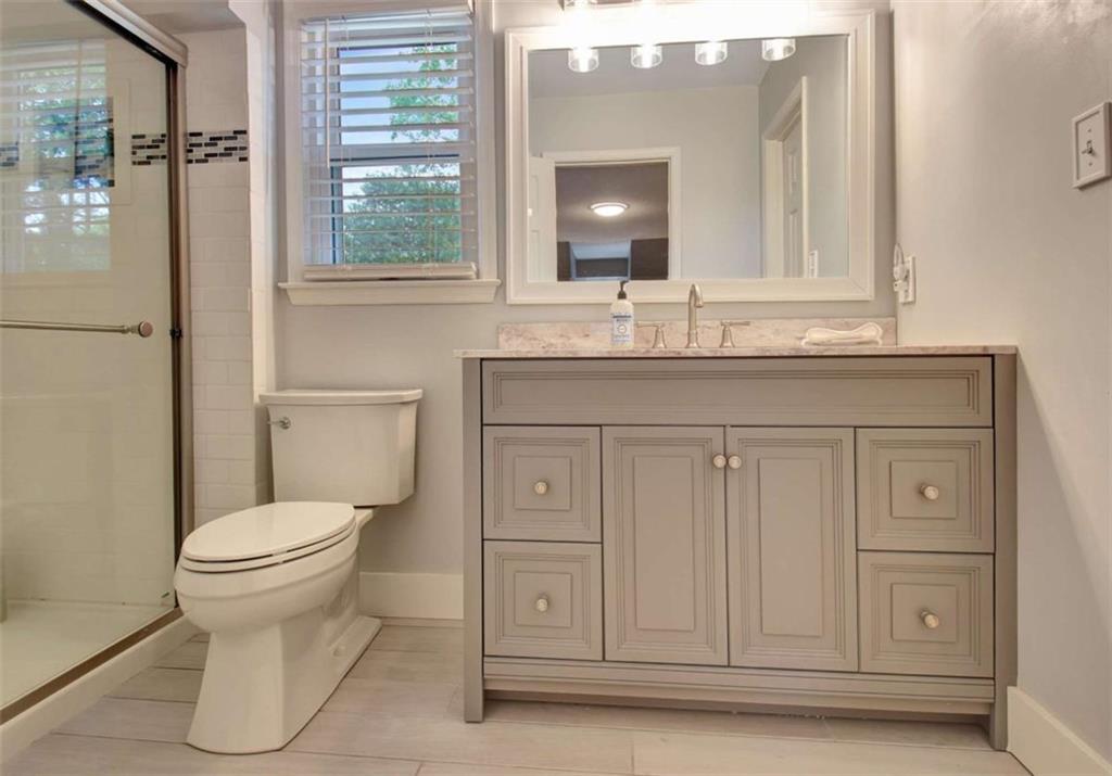 110 Sandtrap Ridge Peachtree City, GA 30269 - Photo 65 of 85 a bathroom with a granite countertop toilet sink and mirror