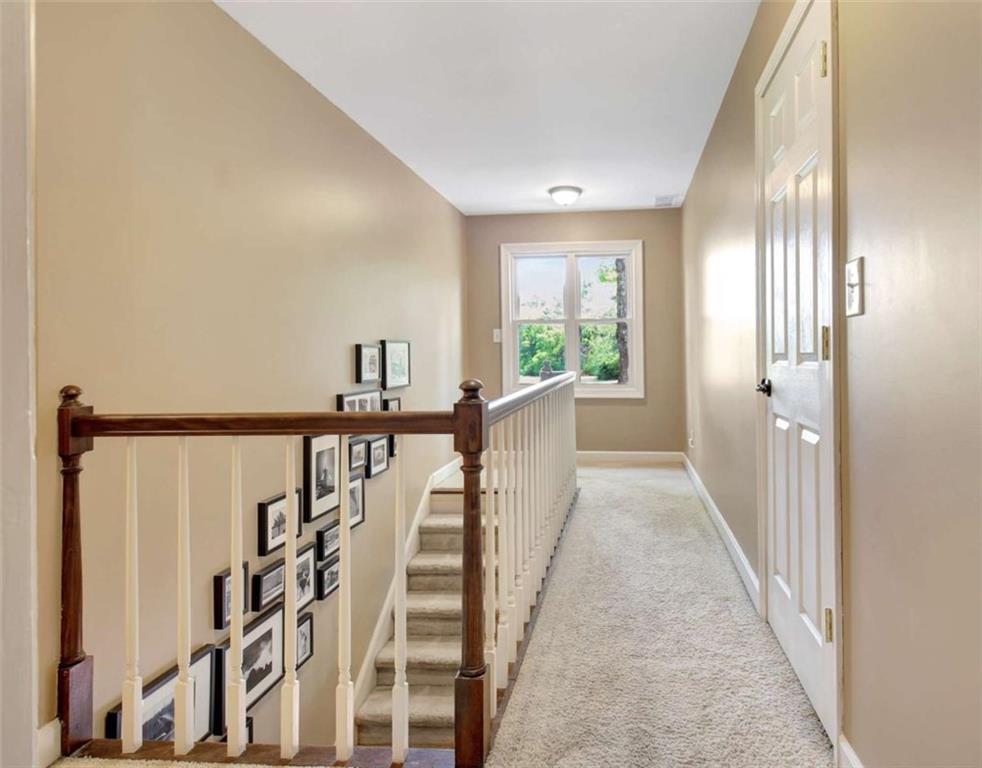 110 Sandtrap Ridge Peachtree City, GA 30269 - Photo 69 of 85 a view of a hallway with wooden floor and windows