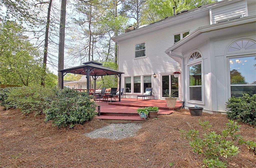 110 Sandtrap Ridge Peachtree City, GA 30269 - Photo 81 of 85 a view of backyard with swimming pool and table and chairs under an umbrella
