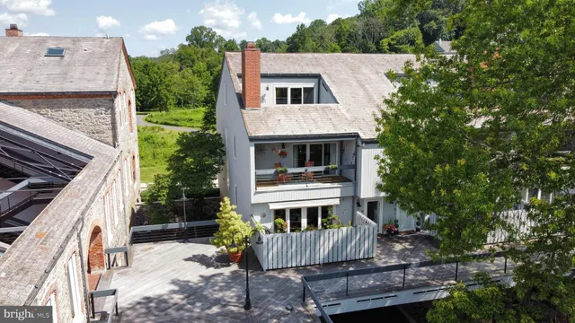 a view of house with yard and sitting area
