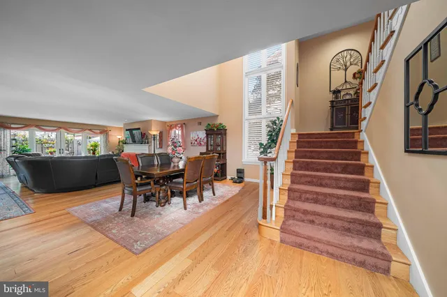 a kitchen with stainless steel appliances granite countertop a stove a sink dishwasher and a refrigerator with wooden floor