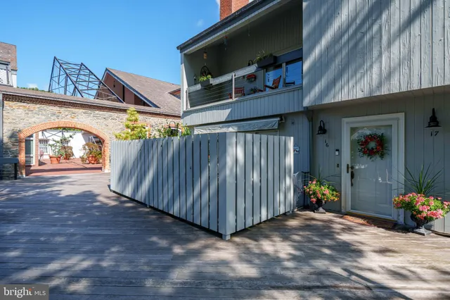a living room with furniture a large window and a flat screen tv