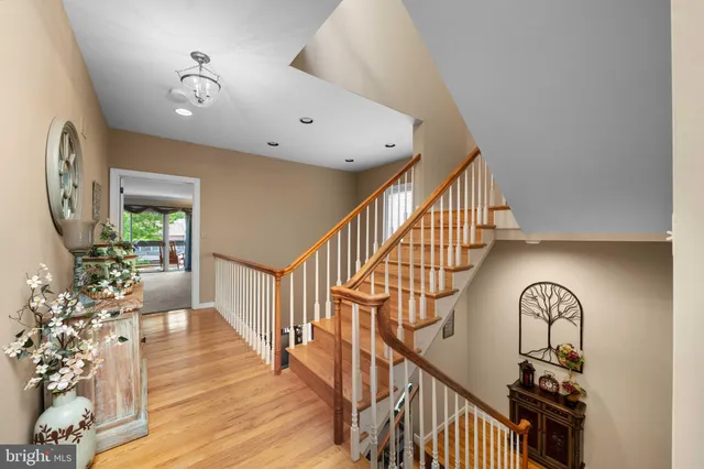 an aerial view of residential house with outdoor space and trees all around