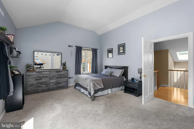 an aerial view of a house with a garden and lake view