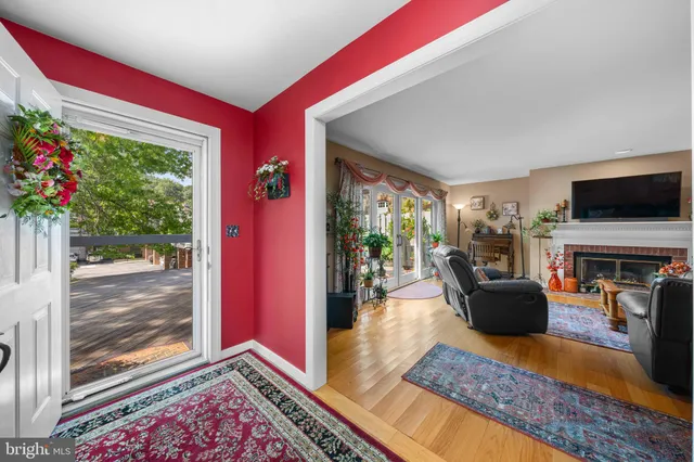 a living room with furniture fireplace and a large window