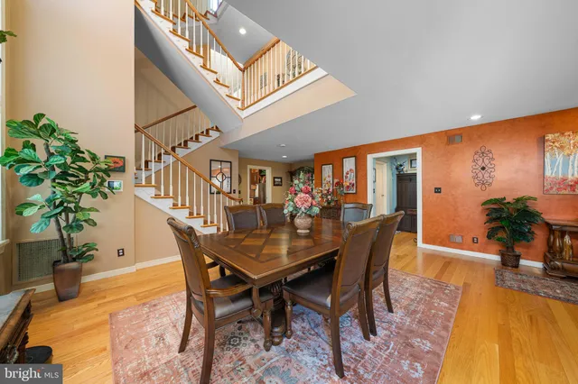 a dining room with furniture and wooden floor