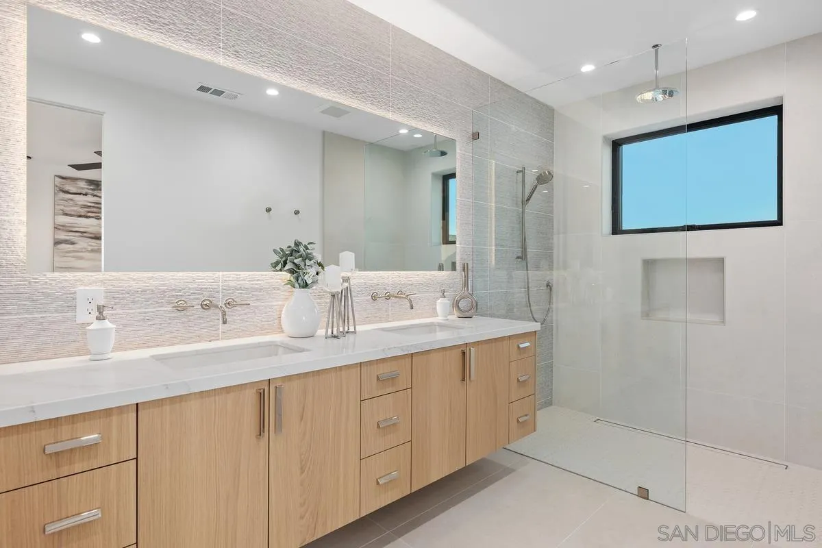 1237 Van Nuys Street San Diego, CA 92109 - Photo 19 of 32 a bathroom with a double vanity sink and a mirror