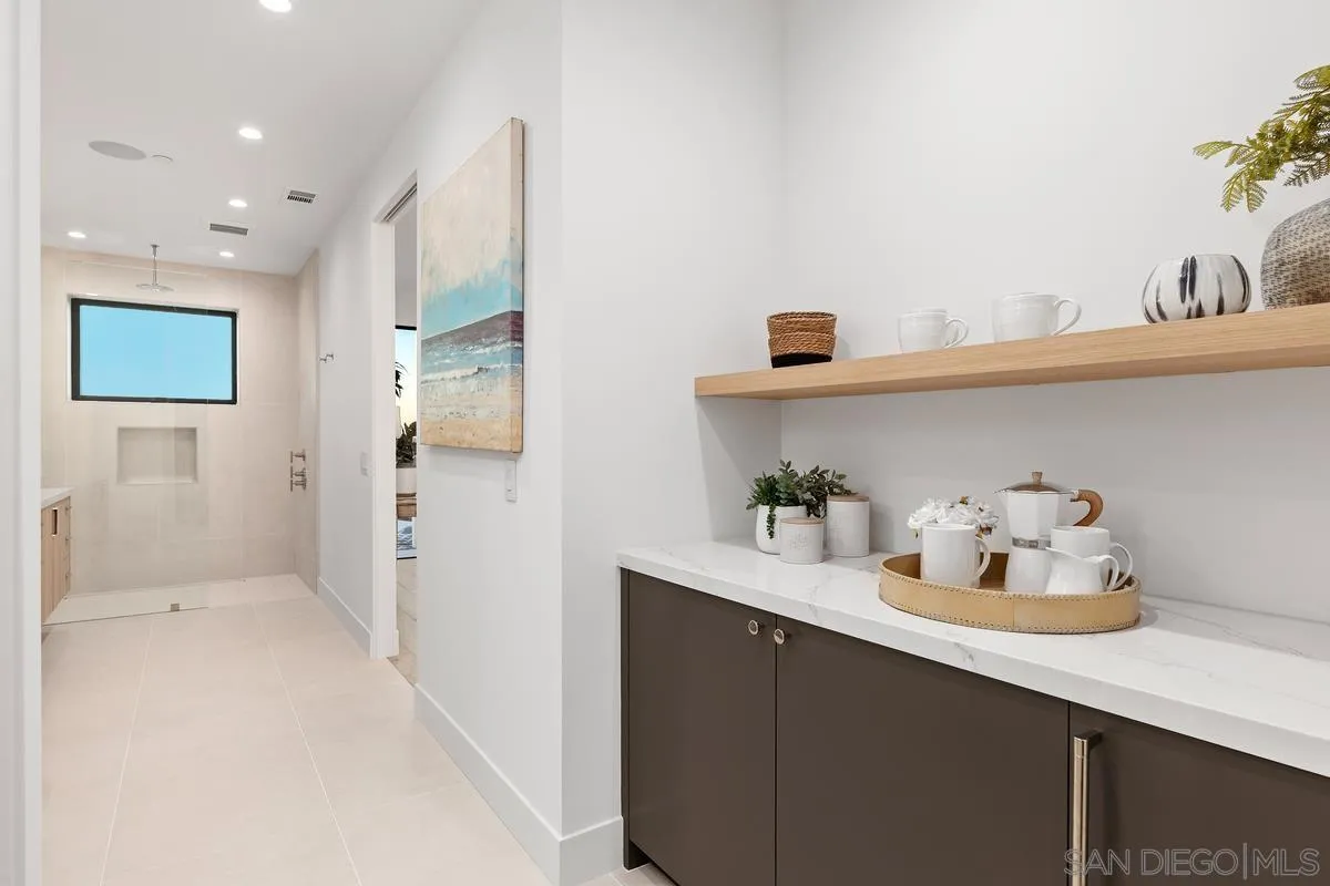 1237 Van Nuys Street San Diego, CA 92109 - Photo 20 of 32 a bathroom with a sink a mirror and shower