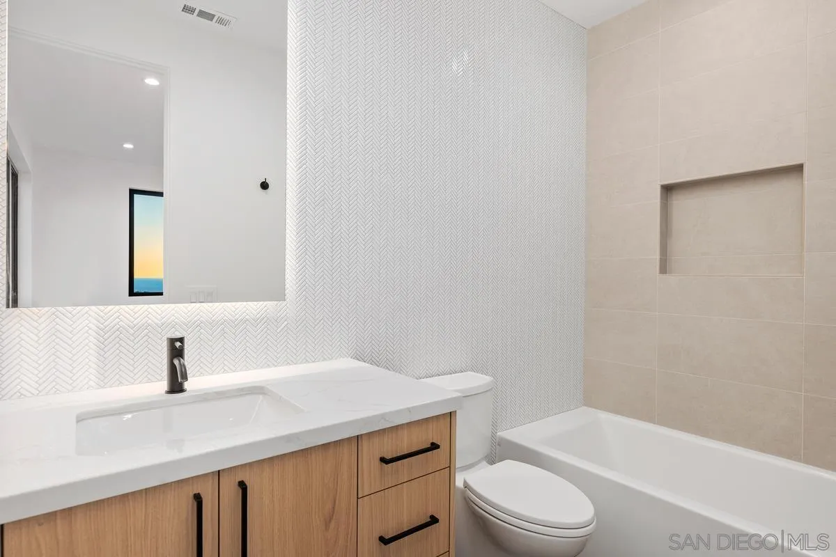 1237 Van Nuys Street San Diego, CA 92109 - Photo 23 of 32 a bathroom with a sink a toilet and shower