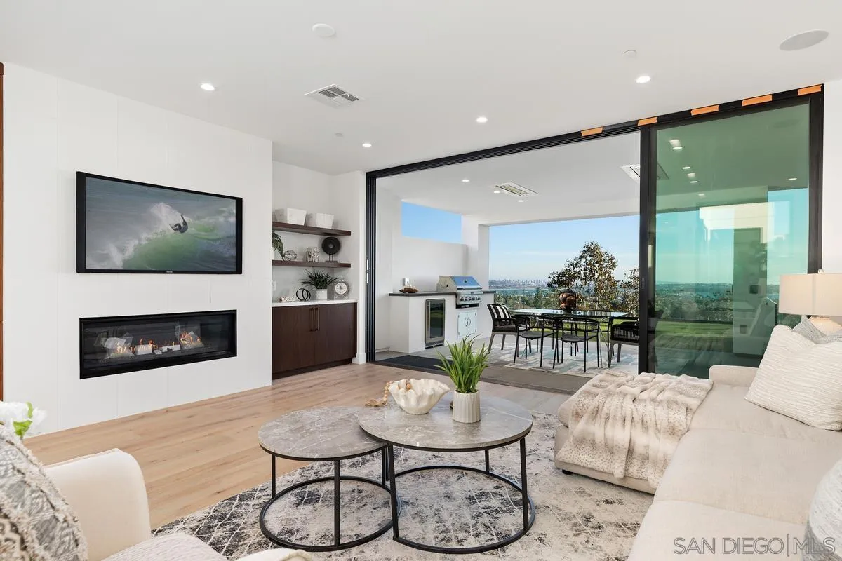 1237 Van Nuys Street San Diego, CA 92109 - Photo 10 of 32 a living room with furniture a flat screen tv and a fireplace