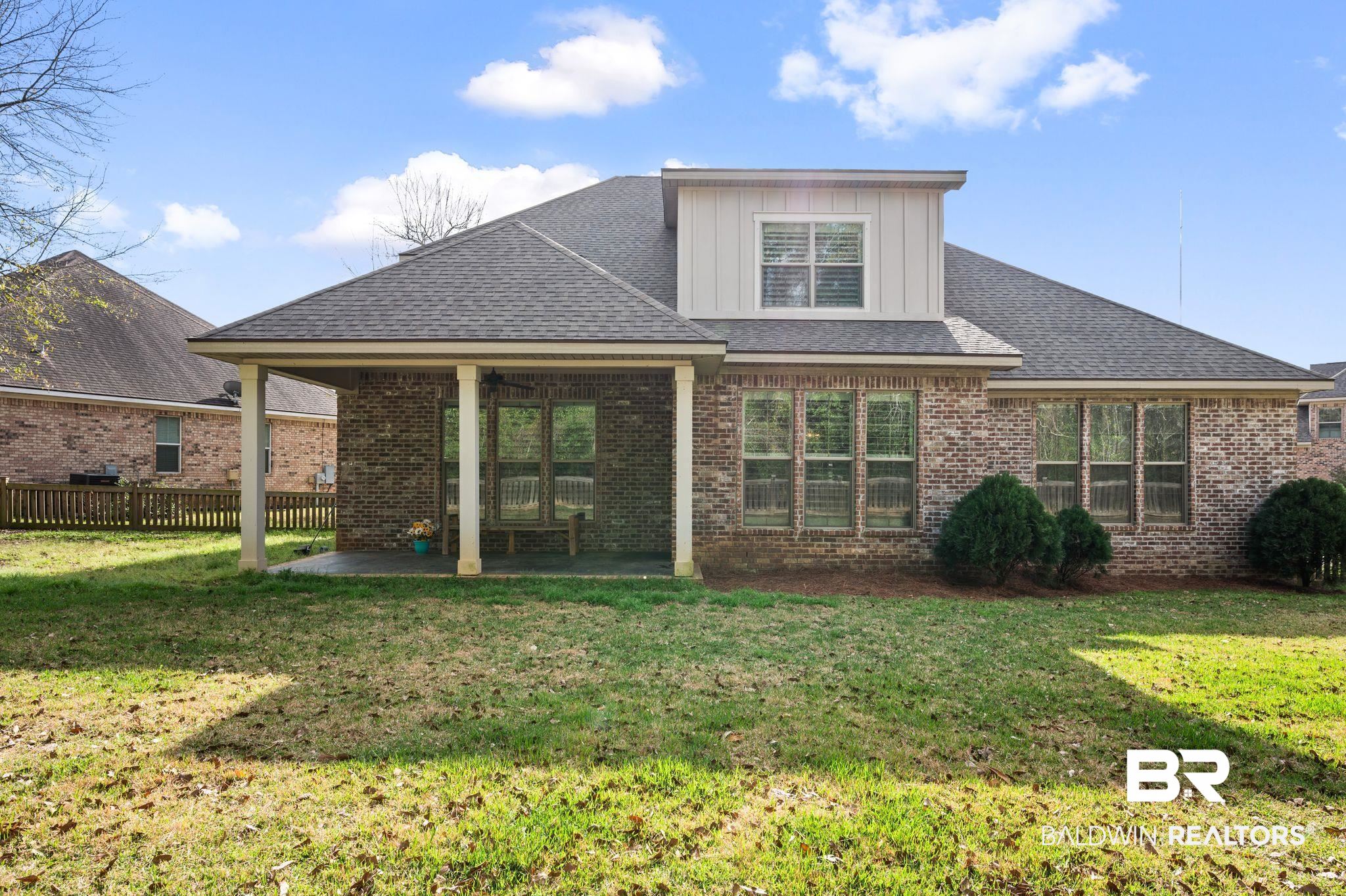 32194 Badger Court Daphne, AL 36527 - Photo 40 of 49 Back of property with a patio area, brick siding, a shingled roof, and board and batten siding