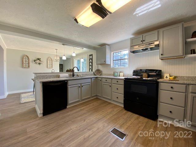 2509 Pinckney Road Chester, SC 29706 - Photo 11 of 19 a kitchen with stainless steel appliances granite countertop a sink cabinets and wooden floor
