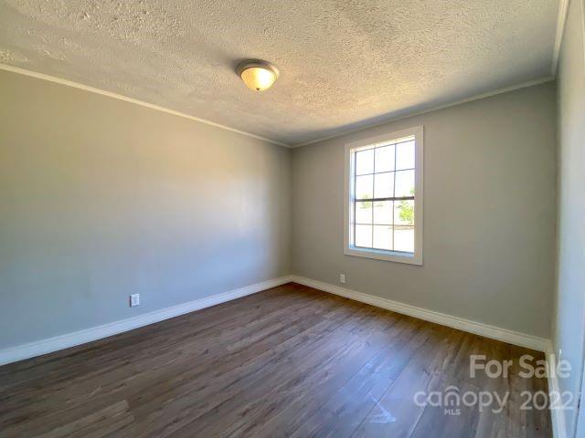 2509 Pinckney Road Chester, SC 29706 - Photo 14 of 19 an empty room with wooden floor and windows