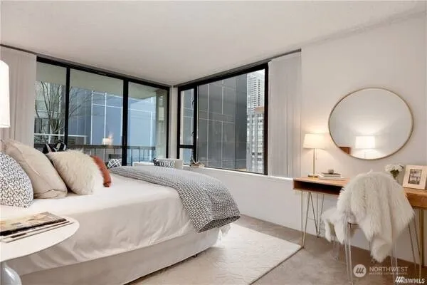 a bedroom with a large bed and a large window