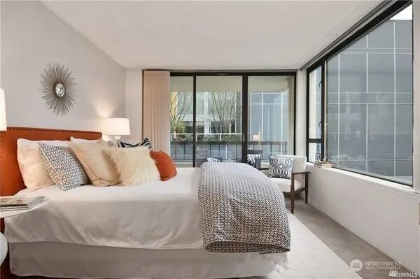 a bedroom with a large bed and a large window