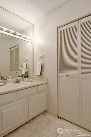2201 3rd Avenue, Unit 804 Seattle, WA 98121 - Photo 15 of 22 a bathroom with a double vanity sink and mirror