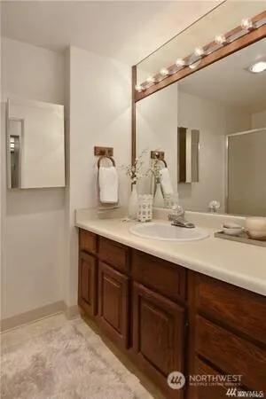 a bathroom with a double vanity sink and a mirror