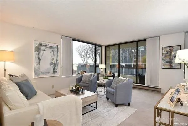 a living room with furniture and large windows
