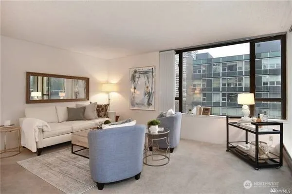 a living room with furniture and a floor to ceiling window