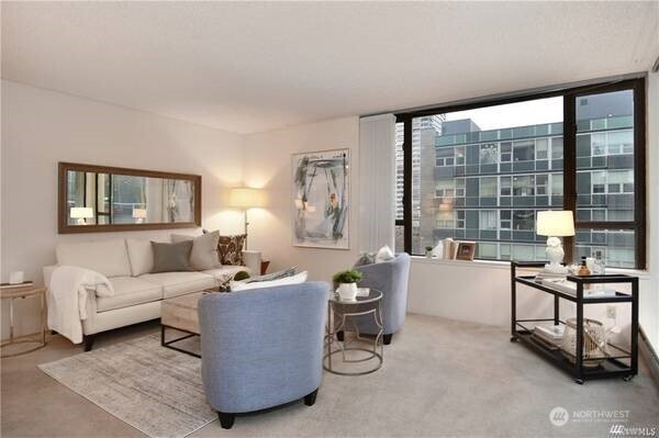 2201 3rd Avenue, Unit 804 Seattle, WA 98121 - Photo 3 of 22 a living room with furniture and a floor to ceiling window