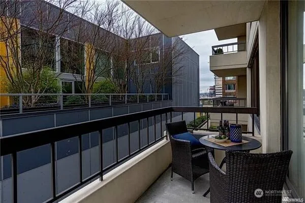 a view of a chairs and table in the balcony