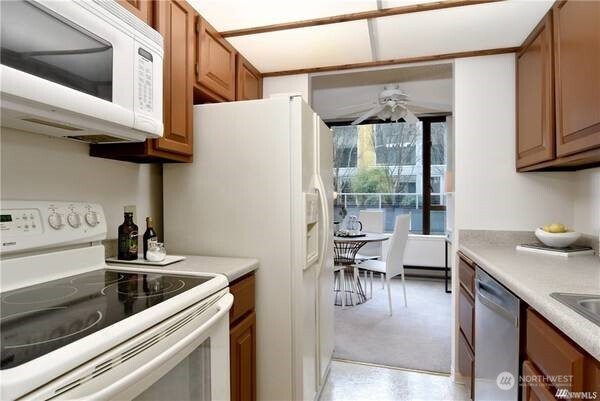 2201 3rd Avenue, Unit 804 Seattle, WA 98121 - Photo 9 of 22 a kitchen with stainless steel appliances granite countertop a sink a stove and a refrigerator