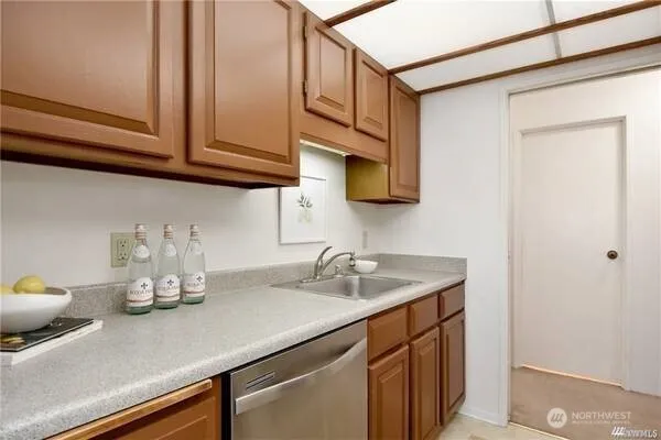 a kitchen with a sink dishwasher and cabinets