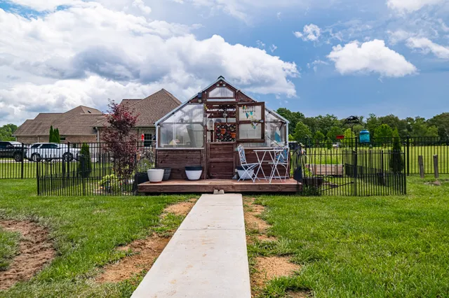 a view of a house with a yard and sitting area