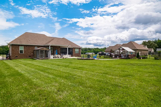 a view of a house with a yard and sitting area