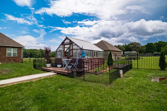 a view of a house with a backyard patio and swimming pool