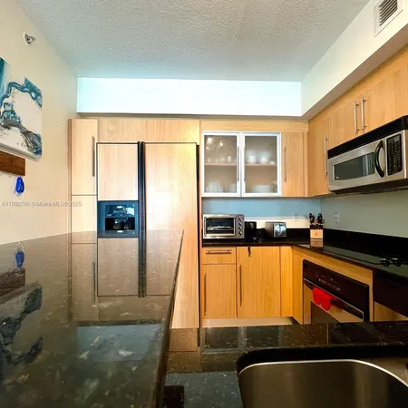 a bedroom with a bed and painting on the wall