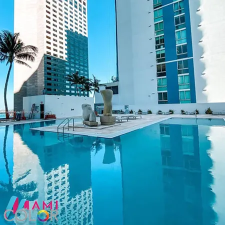 a swimming pool with buildings in the background