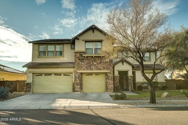 a front view of a house with a yard and garage