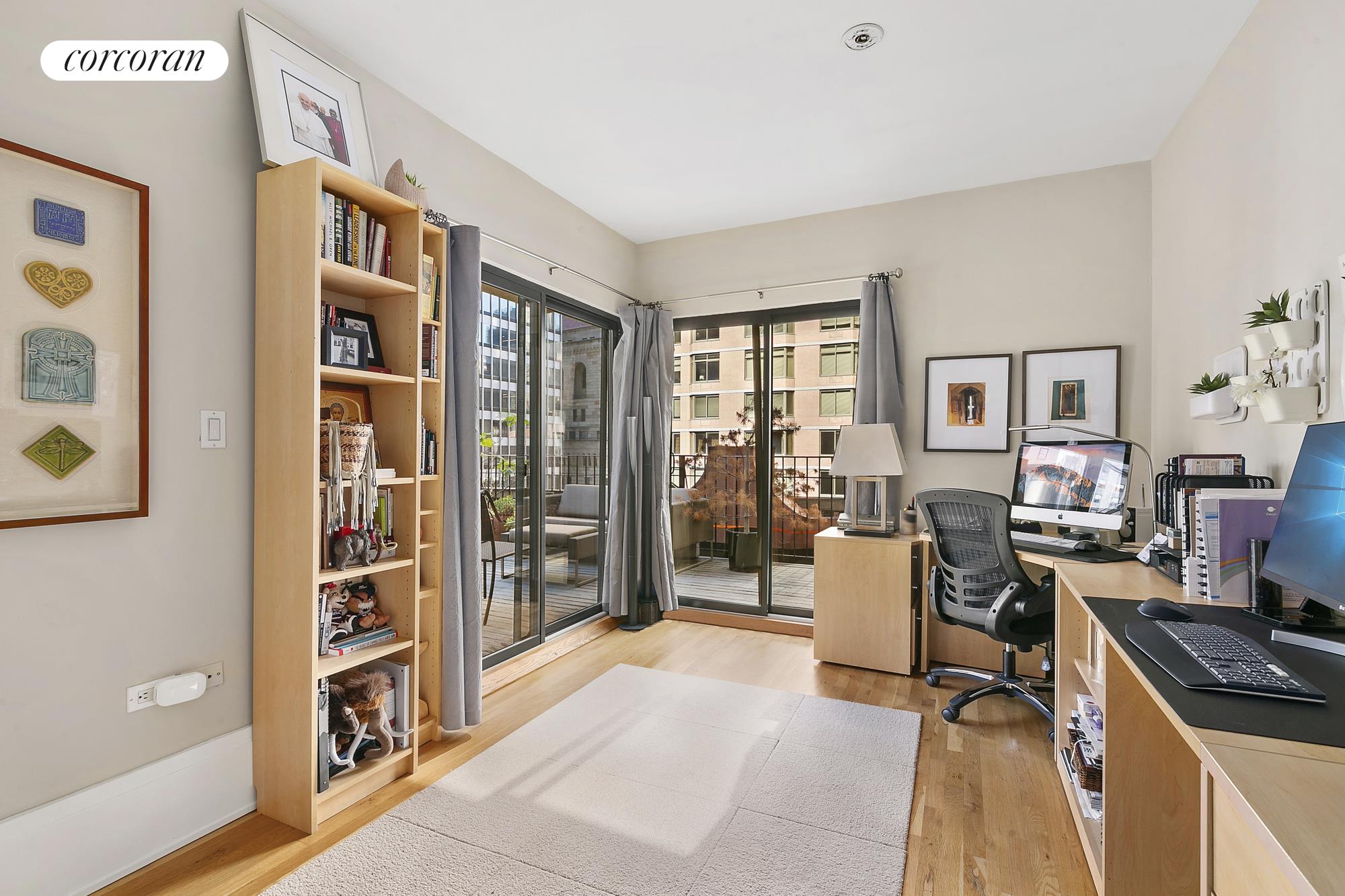 50 Pine Street, Unit PH12N Manhattan, NY 10005 - Photo 7 of 10 a living room with furniture a bookshelf and a window