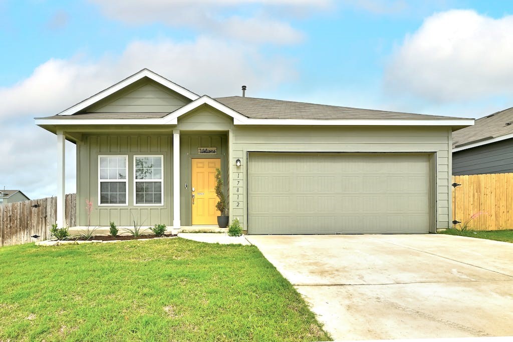 17812 Rye Spring Drive Elgin, TX 78621 - Photo 1 of 1 a front view of a house with a yard and garage
