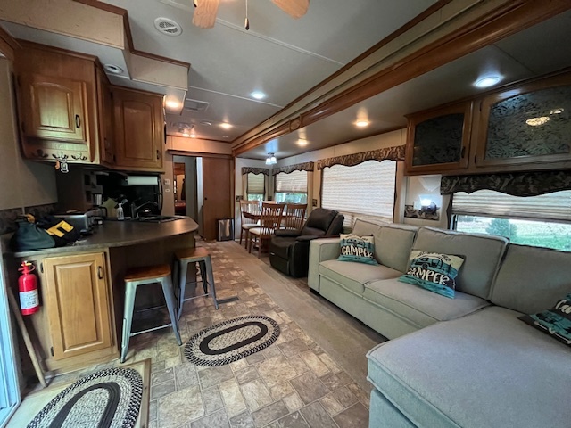2795 East 28th Road Marseilles, IL 61341 - Photo 17 of 73 a living room with furniture a flat screen tv and kitchen view