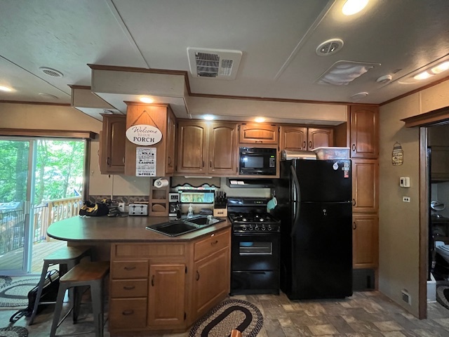 2795 East 28th Road Marseilles, IL 61341 - Photo 20 of 73 a kitchen with stainless steel appliances kitchen island granite countertop a refrigerator a stove a sink and dishwasher with a dining table